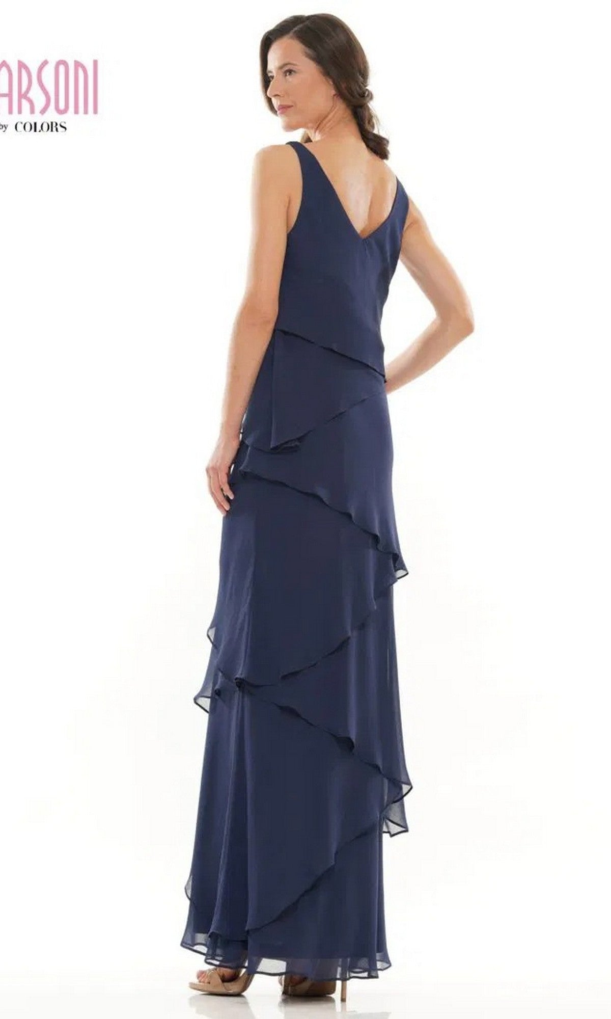 A woman in the Marsoni M309 long formal dress, a sleeveless navy blue chiffon gown with tiered ruffles, stands against a white background.
